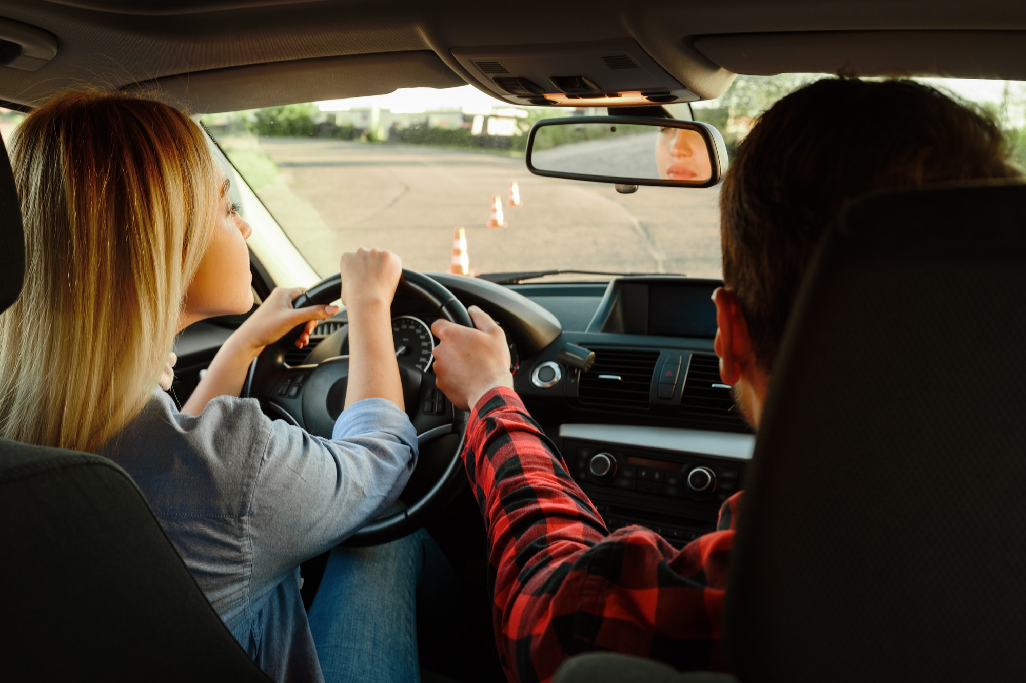 instructor-helps-woman-to-drive-the-car-1.jpg